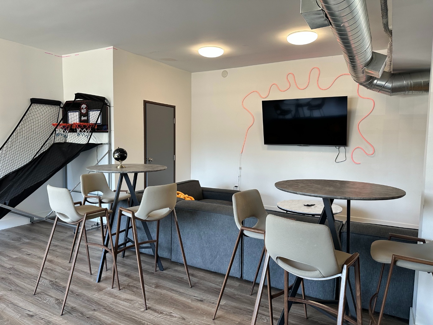 Sofa and bistro tables in the social common area at Heritage 2831