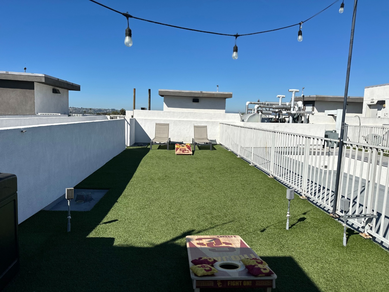 Outdoor social lounge with corn hole at Heritage 1275