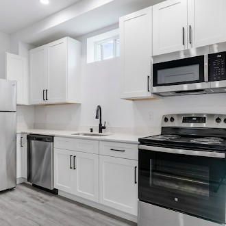 Kitchen with stainless-steel appliances at The Bungalows